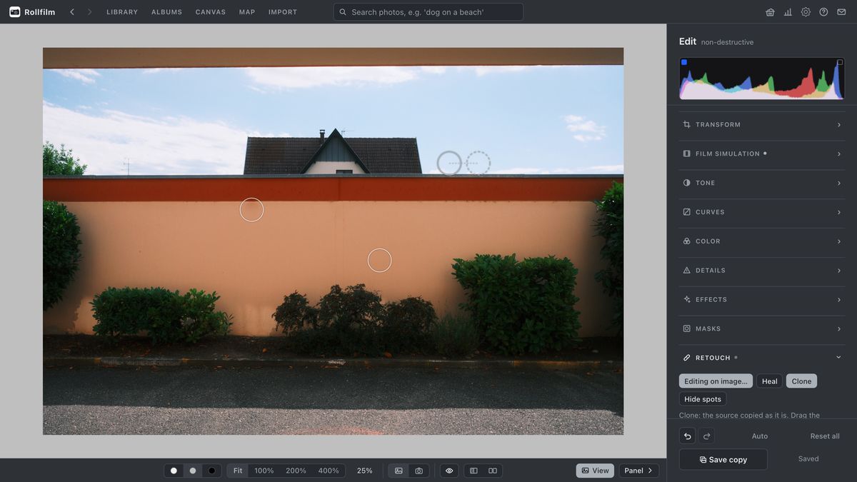 The editor's Retouch section: two heal spots on a wall and a clone spot in the sky with its dashed source circle beside it.
